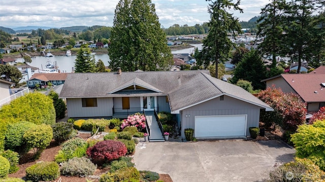 228 Skagit Way, La Conner, WA 98257 - single story home featuring asphalt driveway, a water view, and an attached garage