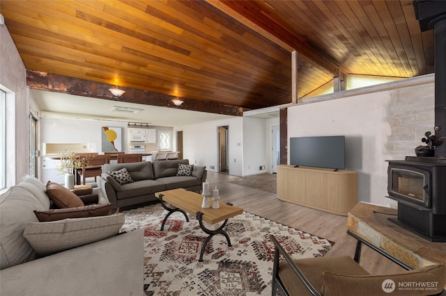 228 Skagit Way, La Conner, WA 98257 - living room with a wood stove, wood finished floors, and wooden ceiling