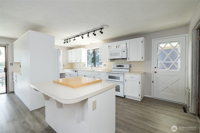 228 Skagit Way, La Conner, WA 98257 - kitchen featuring white appliances, track lighting, white cabinetry, and dark wood-style flooring