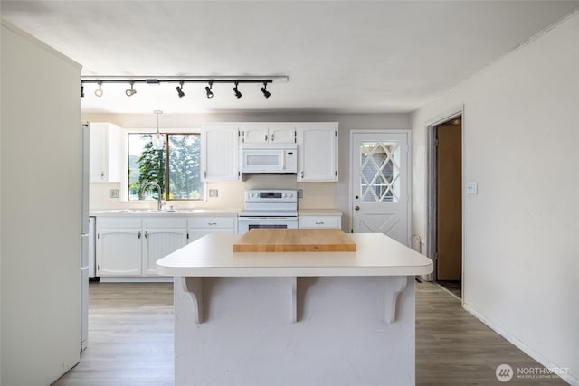 228 Skagit Way, La Conner, WA 98257 - kitchen with white appliances, a sink, white cabinetry, and light countertops
