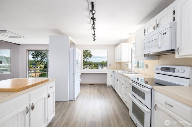 228 Skagit Way, La Conner, WA 98257 - kitchen with white appliances, a sink, light countertops, and white cabinetry