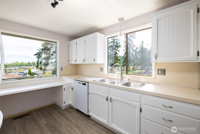 228 Skagit Way, La Conner, WA 98257 - kitchen featuring dishwasher, a sink, wood finished floors, white cabinetry, and light countertops