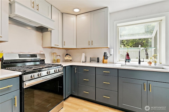 19414 112th Ave E, Graham, WA 98338 - kitchen featuring gas range, extractor fan, a sink, gray cabinets, and light countertops