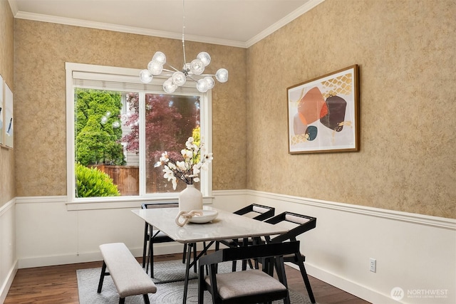 dining area featuring a chandelier, wood finished floors, ornamental molding, and baseboards