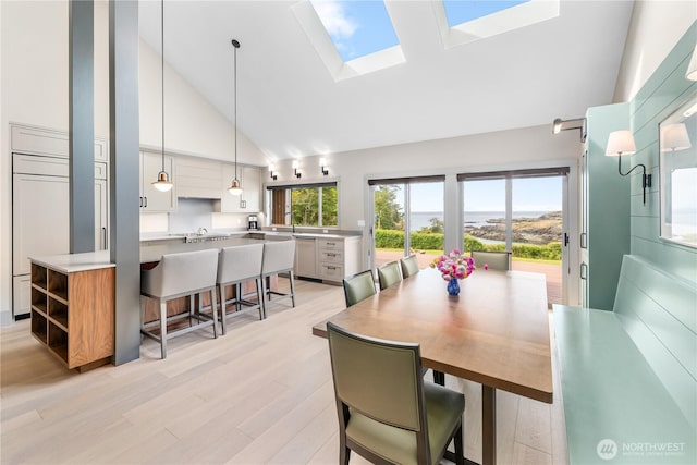 1248 Kanaka Bay Rd, Friday Harbor, WA 98250 - dining room featuring high vaulted ceiling, a skylight, and light wood-style flooring