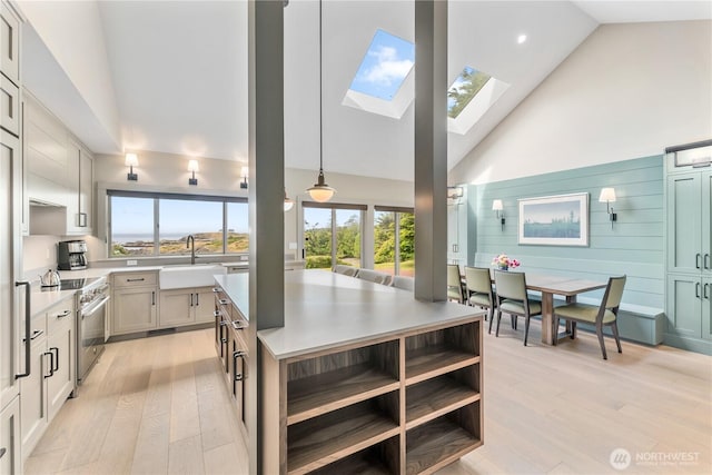 1248 Kanaka Bay Rd, Friday Harbor, WA 98250 - kitchen featuring a sink, stainless steel range, a skylight, high vaulted ceiling, and light wood-style floors