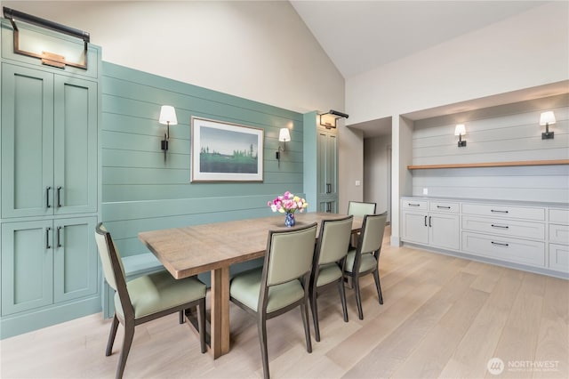 1248 Kanaka Bay Rd, Friday Harbor, WA 98250 - dining space featuring light wood-type flooring, high vaulted ceiling, and wood walls