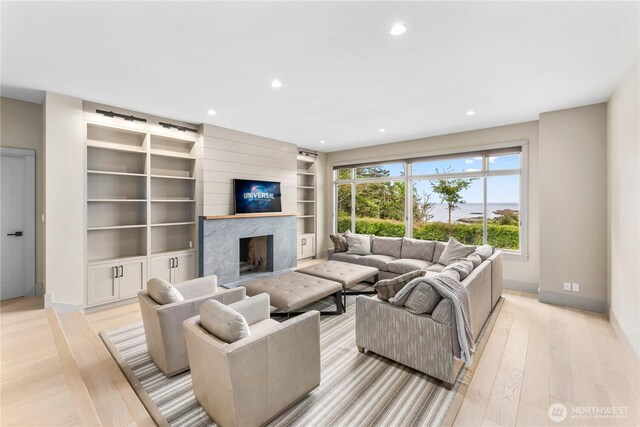 1248 Kanaka Bay Rd, Friday Harbor, WA 98250 - living area featuring baseboards, light wood-style floors, recessed lighting, a high end fireplace, and built in shelves