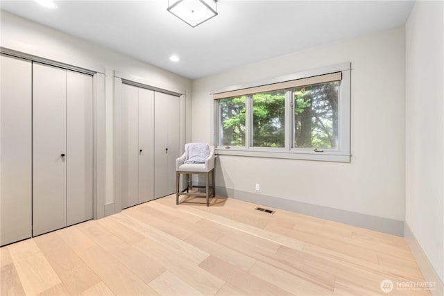 1248 Kanaka Bay Rd, Friday Harbor, WA 98250 - unfurnished bedroom featuring multiple closets, wood finished floors, recessed lighting, and baseboards