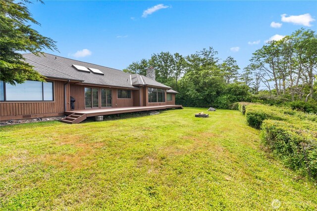 1248 Kanaka Bay Rd, Friday Harbor, WA 98250 - view of green lawn featuring a wooden deck and an outdoor fire pit