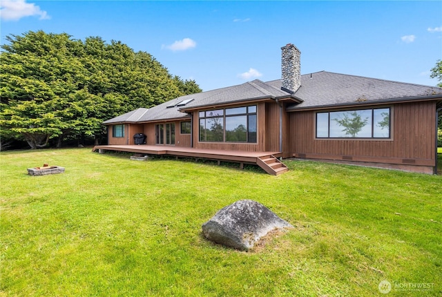 1248 Kanaka Bay Rd, Friday Harbor, WA 98250 - back of property with a deck, a chimney, an outdoor fire pit, and a lawn