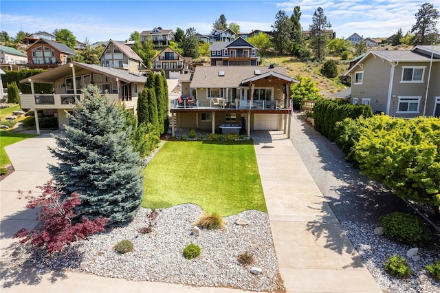 250 Lakefront Dr, Orondo, WA 98843 - view of front facade featuring a residential view, concrete driveway, an attached garage, a front lawn, and a balcony