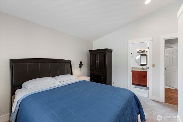250 Lakefront Dr, Orondo, WA 98843 - bedroom featuring vaulted ceiling, a sink, light colored carpet, ensuite bath, and baseboards
