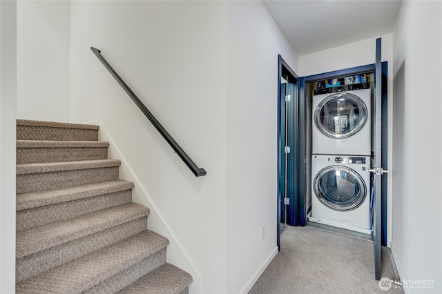 4216 30th Ave SW, Seattle, WA 98126 - laundry area featuring stacked washing machine and dryer, carpet flooring, and baseboards