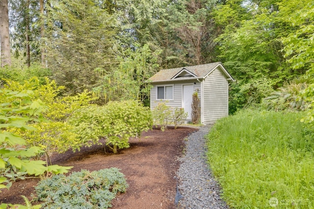 view of shed featuring a wooded view