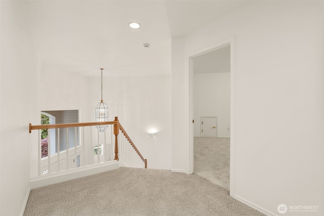 corridor featuring an upstairs landing, carpet, baseboards, and recessed lighting