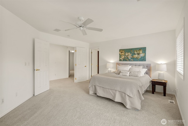 carpeted bedroom featuring ceiling fan and baseboards