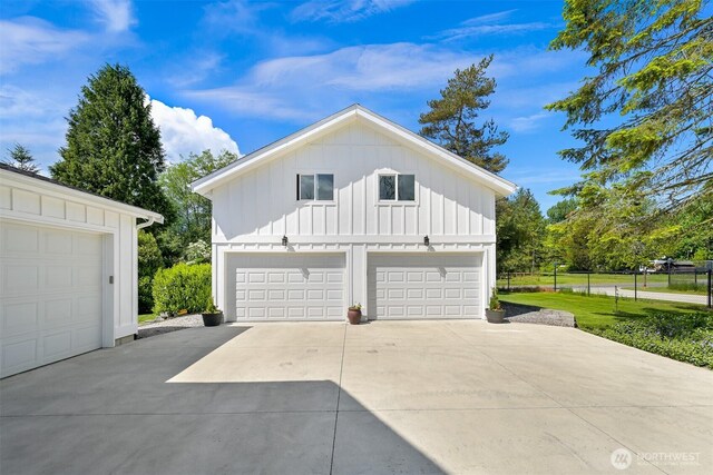8894 Giles Rd, Blaine, WA 98230 - view of side of home featuring board and batten siding, a detached garage, and fence
