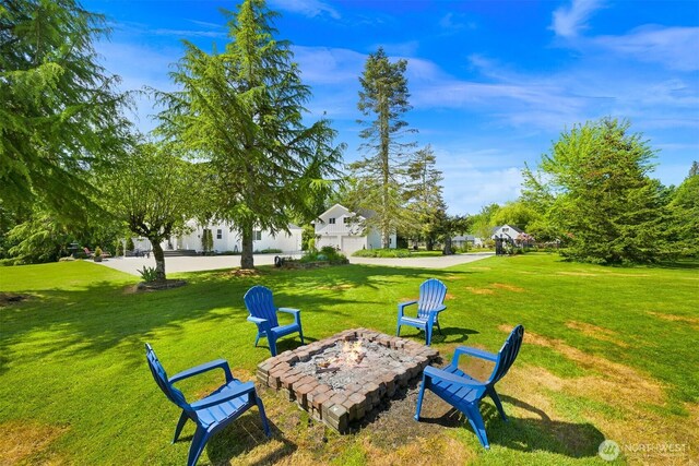 8894 Giles Rd, Blaine, WA 98230 - view of grassy yard with an outdoor fire pit