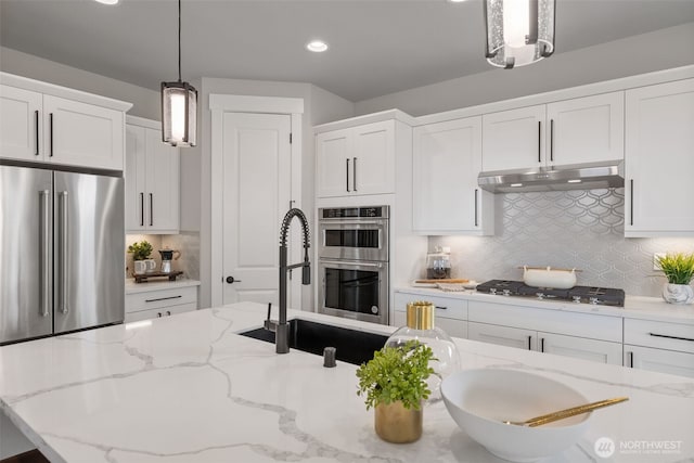20029 7th Ave SE, Bothell, WA 98012 - kitchen with stainless steel appliances, under cabinet range hood, tasteful backsplash, white cabinets, and recessed lighting