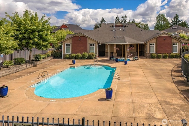 13426 97th Ave E Unit 303, Puyallup, WA 98373 - view of swimming pool with a patio area and fence
