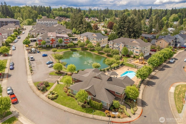 13426 97th Ave E Unit 303, Puyallup, WA 98373 - aerial perspective of suburban area featuring a pool and a nearby body of water