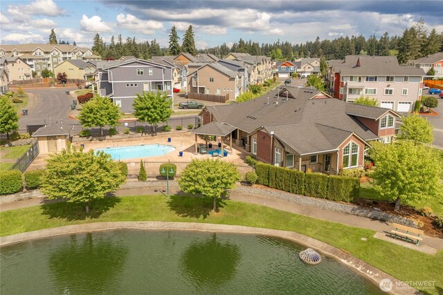 13426 97th Ave E Unit 303, Puyallup, WA 98373 - aerial perspective of suburban area featuring a pool area and a large body of water