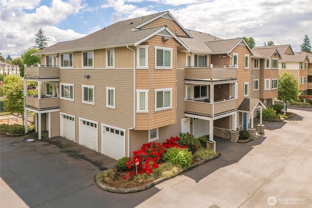 13426 97th Ave E Unit 303, Puyallup, WA 98373 - view of property featuring a garage and driveway