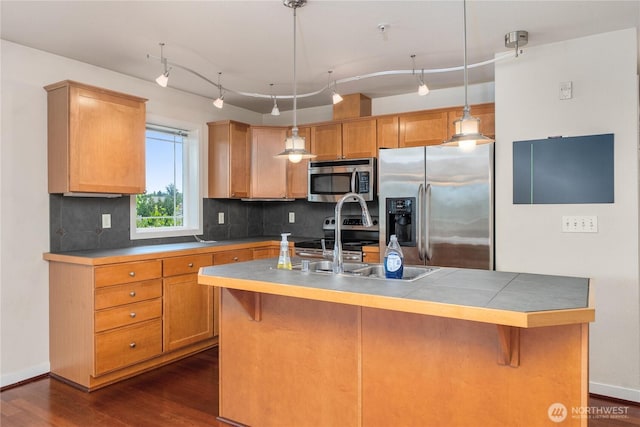 13426 97th Ave E Unit 303, Puyallup, WA 98373 - kitchen featuring stainless steel appliances, track lighting, tasteful backsplash, and dark wood-style flooring