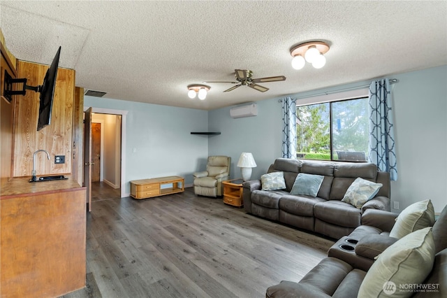 1826 156th St NE, Arlington, WA 98223 - living area with a wall mounted AC, a textured ceiling, a ceiling fan, and wood finished floors