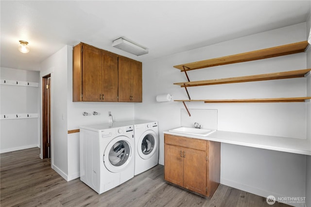 1826 156th St NE, Arlington, WA 98223 - laundry area featuring separate washer and dryer, cabinet space, light wood-style floors, and baseboards