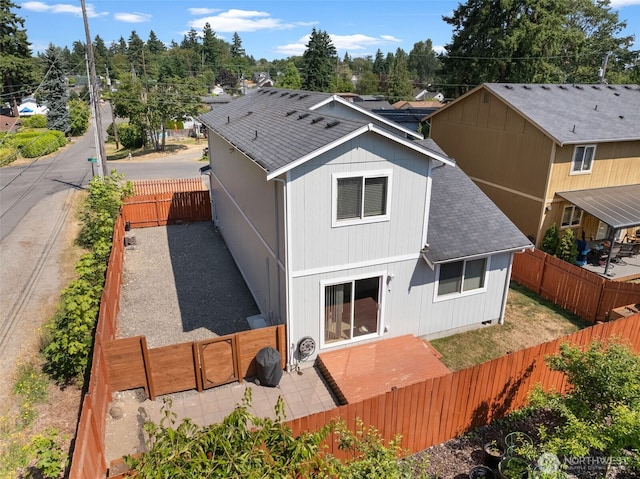10102 Barnes Ln S, Tacoma, WA 98444 - back of property featuring a shingled roof, a fenced backyard, a gate, and a patio area