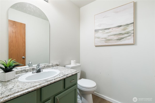 9402 187th St E, Puyallup, WA 98375 - bathroom with toilet, vanity, and wood finished floors