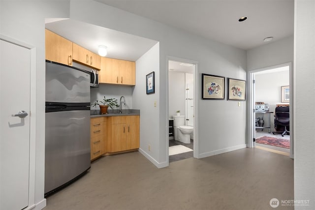 161 Montgomery Ln, Port Ludlow, WA 98365 - kitchen featuring freestanding refrigerator, light brown cabinets, concrete floors, and baseboards