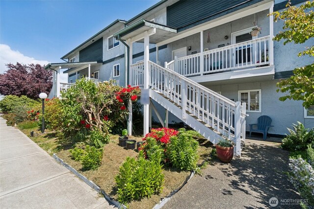 view of home's exterior featuring stucco siding and stairway