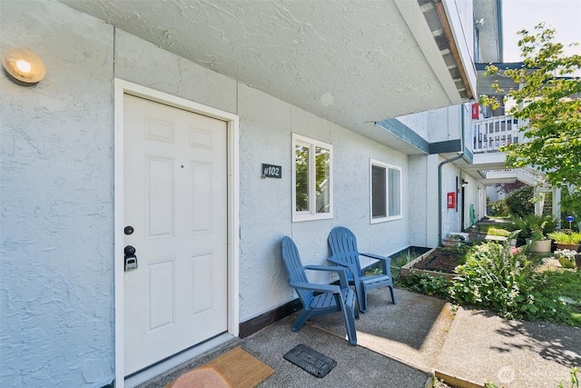entrance to property featuring stucco siding