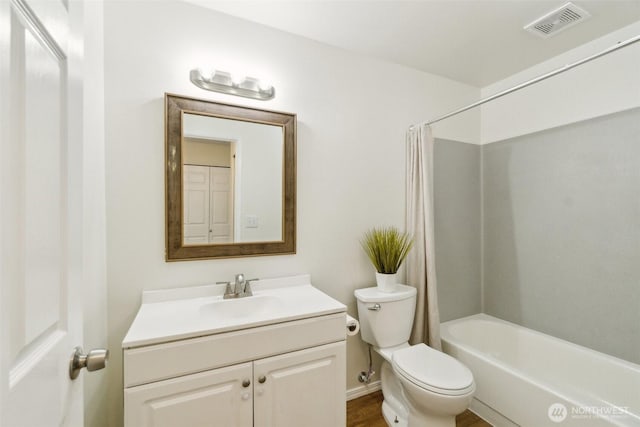 full bath featuring toilet, vanity, and shower / tub combo