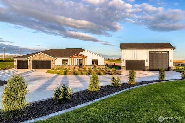 53 Daybreak Rd, Walla Walla, WA 99362 - modern farmhouse style home with stone siding, concrete driveway, board and batten siding, and an outdoor structure