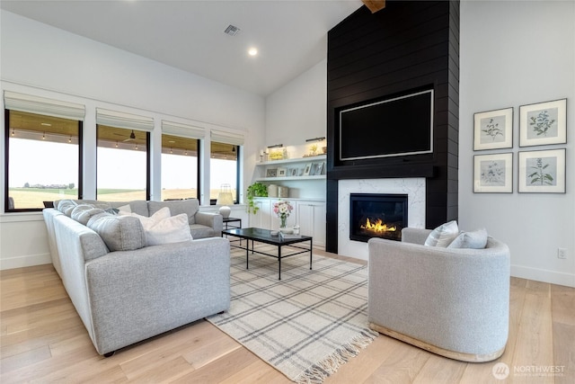 53 Daybreak Rd, Walla Walla, WA 99362 - living area featuring baseboards, light wood-style floors, a premium fireplace, high vaulted ceiling, and recessed lighting
