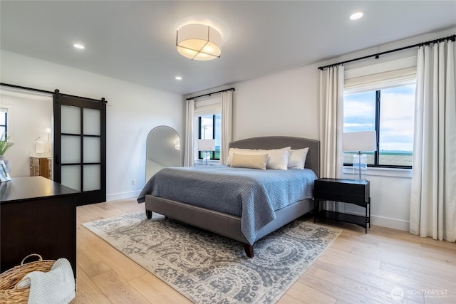 53 Daybreak Rd, Walla Walla, WA 99362 - bedroom featuring a barn door, light wood-type flooring, baseboards, and recessed lighting
