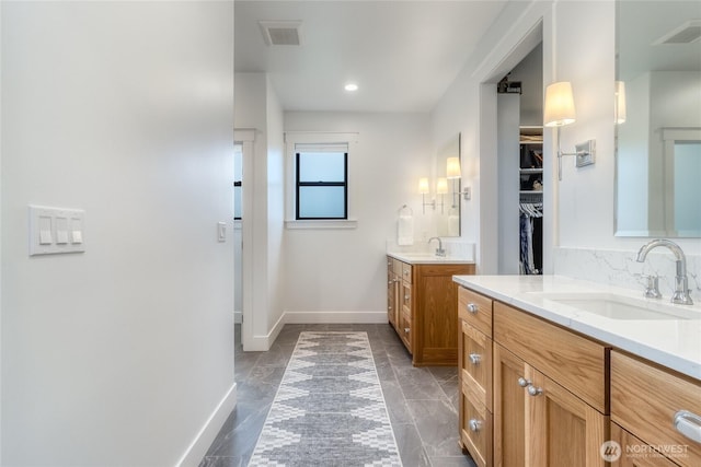 53 Daybreak Rd, Walla Walla, WA 99362 - bathroom with two vanities, baseboards, a spacious closet, and recessed lighting