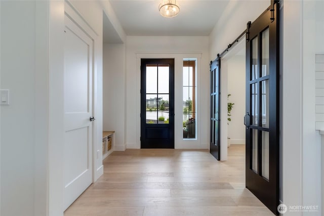 53 Daybreak Rd, Walla Walla, WA 99362 - entrance foyer with a barn door, light wood-style floors, and baseboards