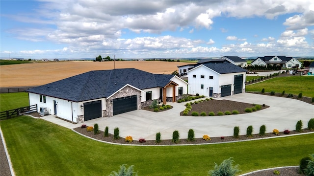 53 Daybreak Rd, Walla Walla, WA 99362 - modern farmhouse style home featuring concrete driveway, an attached garage, stone siding, board and batten siding, and a shingled roof