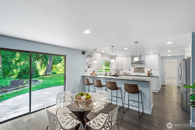 12043 184th Ave NE, Redmond, WA 98052 - dining space featuring dark wood-style flooring, recessed lighting, and a textured ceiling