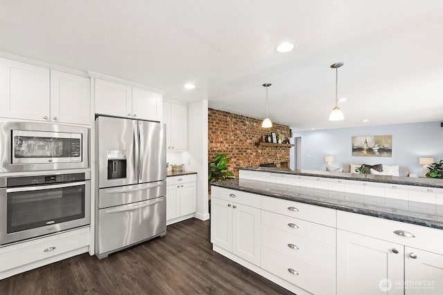 12043 184th Ave NE, Redmond, WA 98052 - kitchen with stainless steel appliances, dark wood finished floors, dark stone counters, white cabinets, and pendant lighting