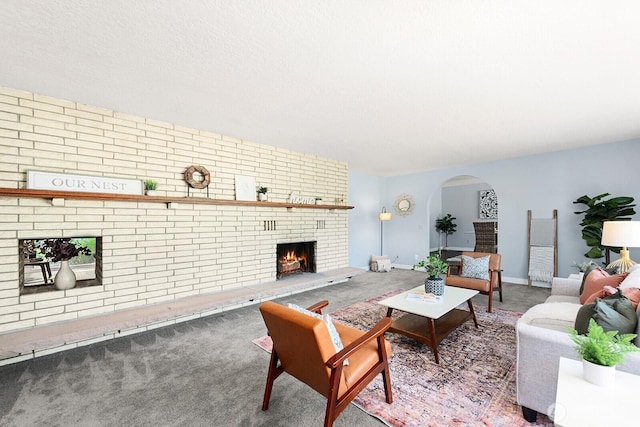 12043 184th Ave NE, Redmond, WA 98052 - living area featuring a brick fireplace, arched walkways, and carpet