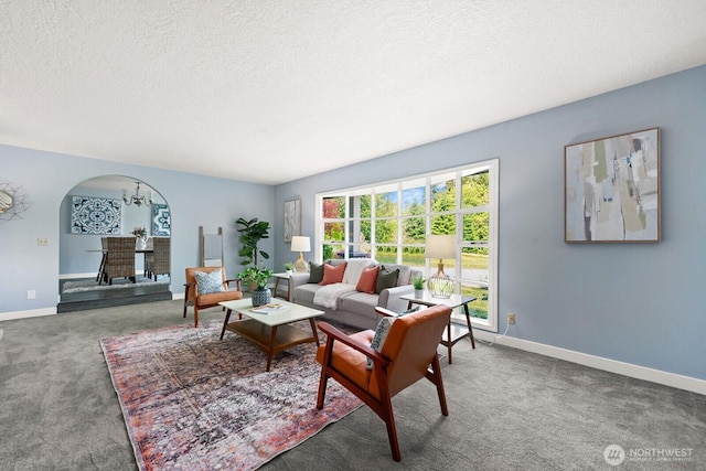 12043 184th Ave NE, Redmond, WA 98052 - living area with arched walkways, carpet floors, and a textured ceiling