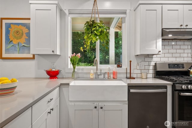 kitchen with stainless steel appliances, a sink, extractor fan, and white cabinets