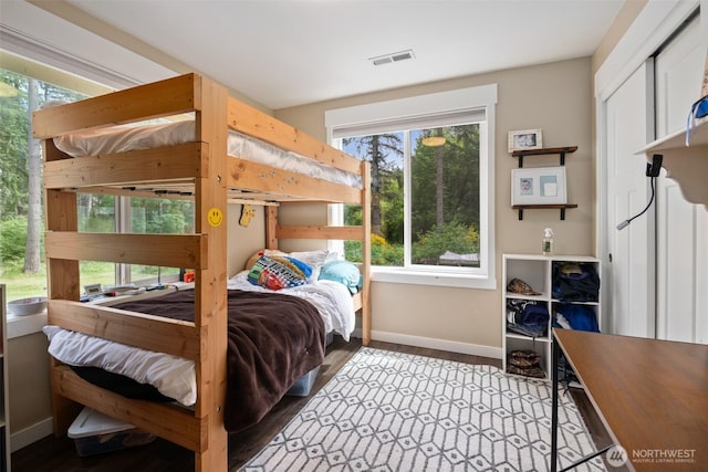 bedroom with baseboards and wood finished floors