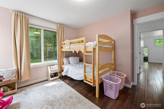 bedroom with baseboards and wood-type flooring